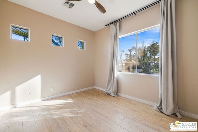 spare room with ceiling fan and light wood-type flooring