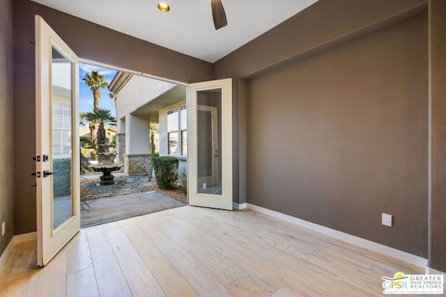 entryway with ceiling fan, french doors, and light hardwood / wood-style floors