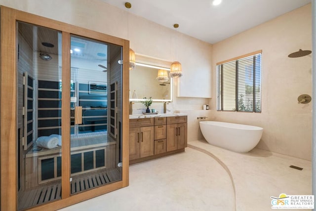 bathroom featuring vanity and independent shower and bath