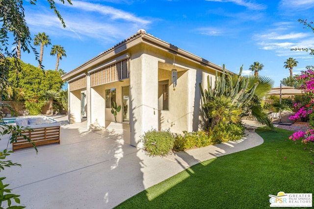 exterior space featuring a yard and a patio