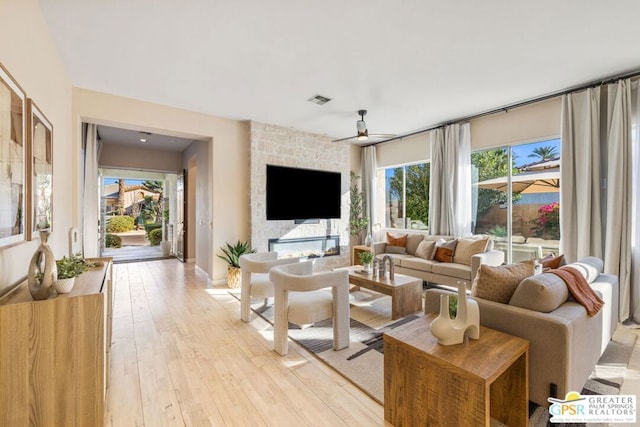 living room featuring ceiling fan and light hardwood / wood-style flooring