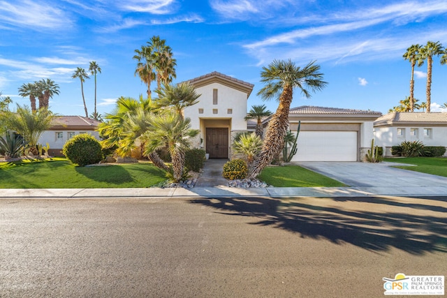 mediterranean / spanish home with a front lawn and a garage