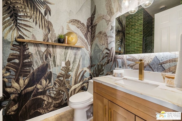 bathroom featuring tile patterned floors, vanity, and toilet