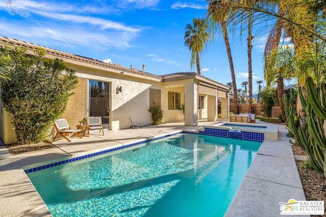 view of pool with an in ground hot tub and a patio