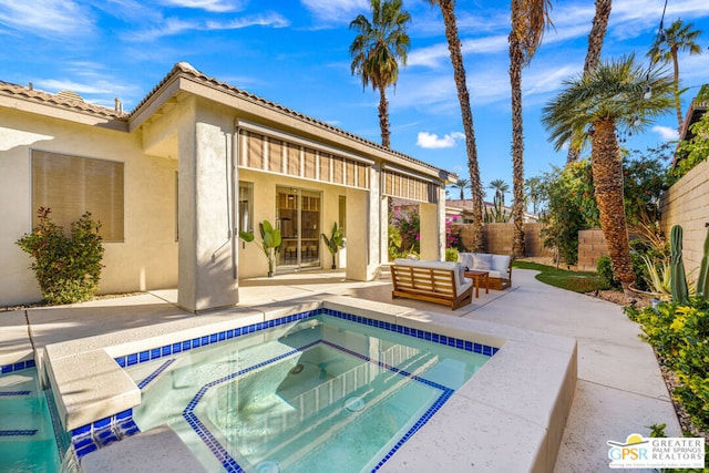 view of pool featuring an in ground hot tub, an outdoor living space, and a patio