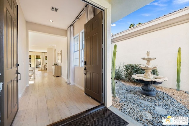 interior space with a wealth of natural light and light hardwood / wood-style floors