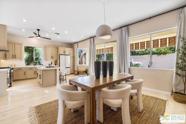 dining area featuring ceiling fan and light hardwood / wood-style flooring