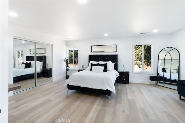 bedroom with a closet and light wood-type flooring