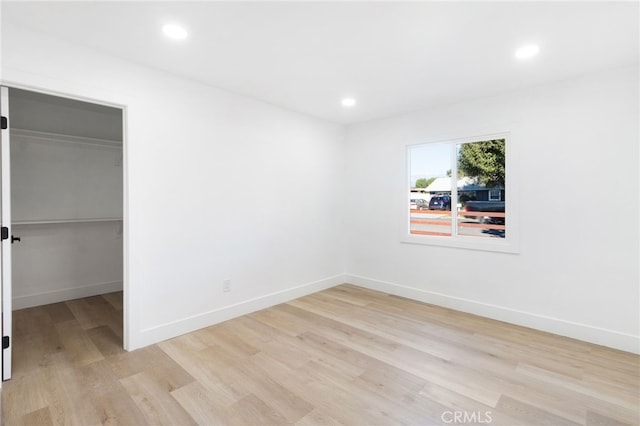 spare room with light hardwood / wood-style floors