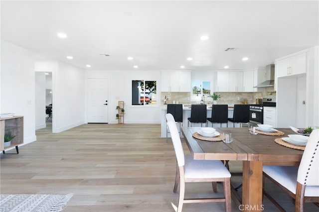 dining space with light hardwood / wood-style flooring