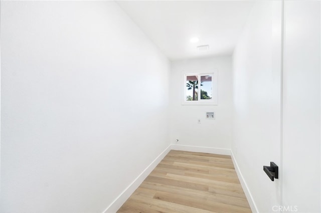 laundry area featuring hookup for a washing machine and light hardwood / wood-style flooring