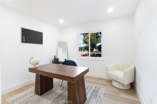 office area with light hardwood / wood-style floors