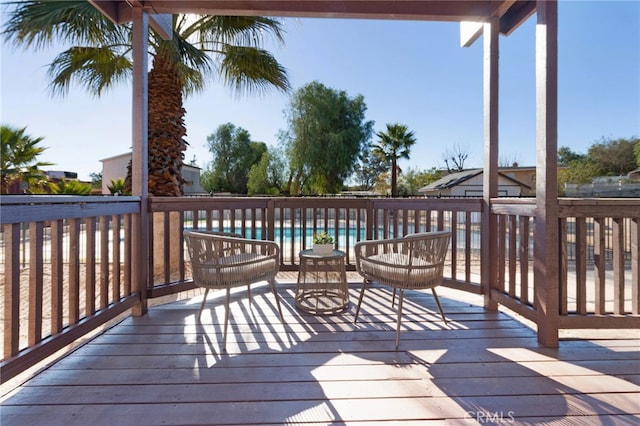 wooden deck featuring a community pool