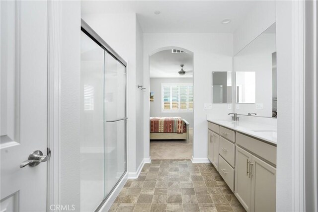 bathroom featuring ceiling fan, vanity, and an enclosed shower