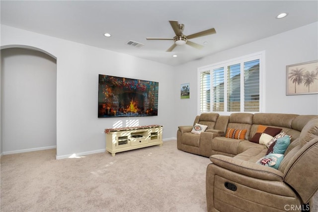 living room with ceiling fan and carpet floors