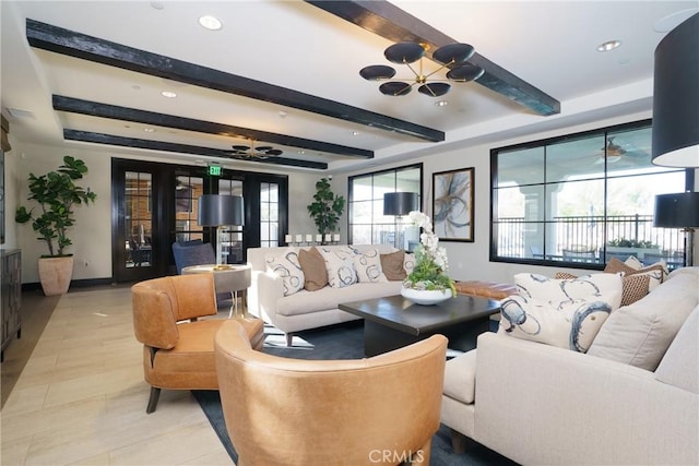 living room featuring beamed ceiling and ceiling fan