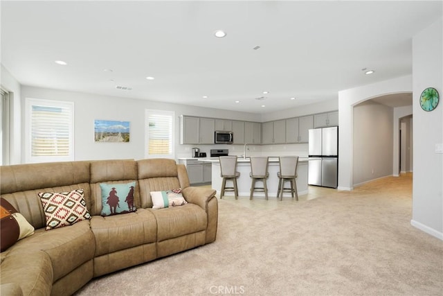 living room with plenty of natural light and light colored carpet