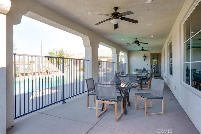 view of patio with ceiling fan and a fenced in pool