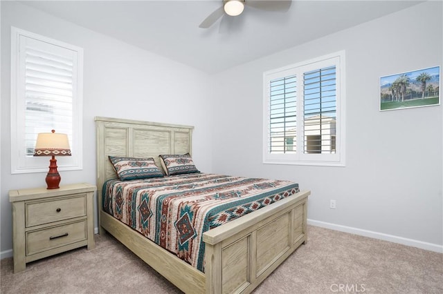 bedroom with ceiling fan and light colored carpet