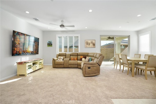 carpeted living room with ceiling fan