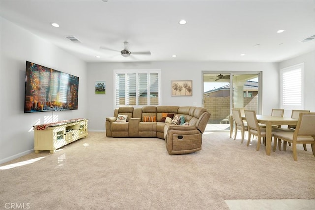 carpeted living room featuring ceiling fan