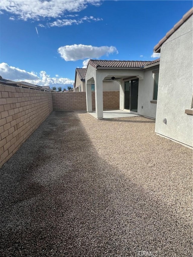 exterior space with a patio and ceiling fan