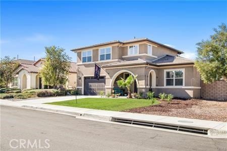 view of front of house with a front yard and a garage