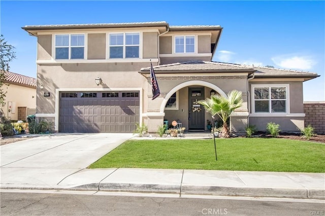 view of front of home with a front yard and a garage