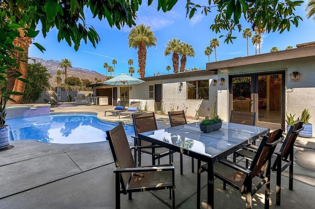 view of pool with a patio area and a mountain view