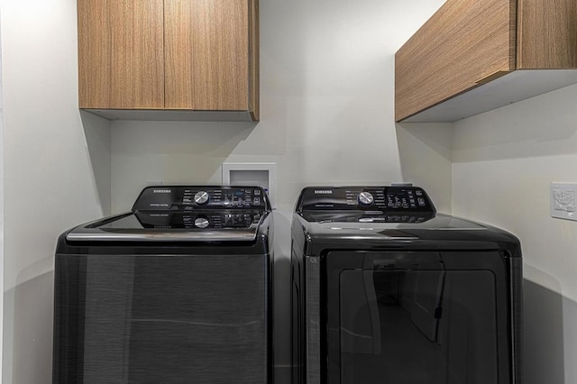 laundry area featuring cabinets and independent washer and dryer