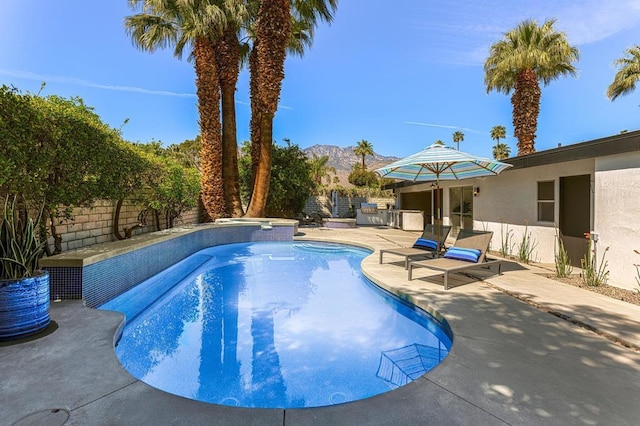 view of pool with a mountain view and a patio area