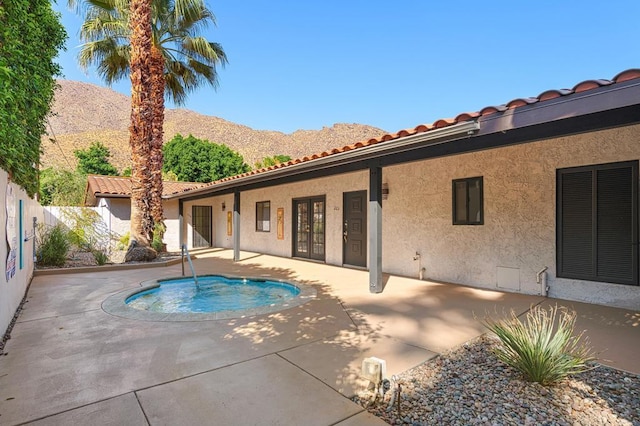 view of pool with a patio and a mountain view