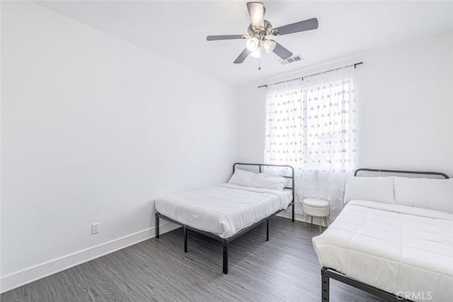 bedroom featuring ceiling fan and dark hardwood / wood-style flooring