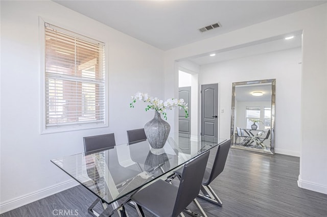 dining room featuring dark hardwood / wood-style flooring and plenty of natural light