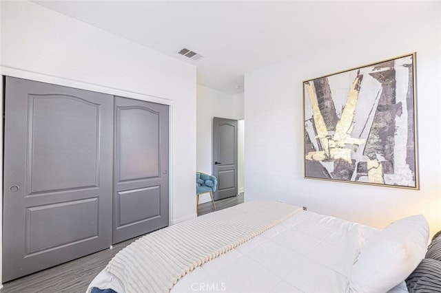 bedroom with hardwood / wood-style floors and a closet