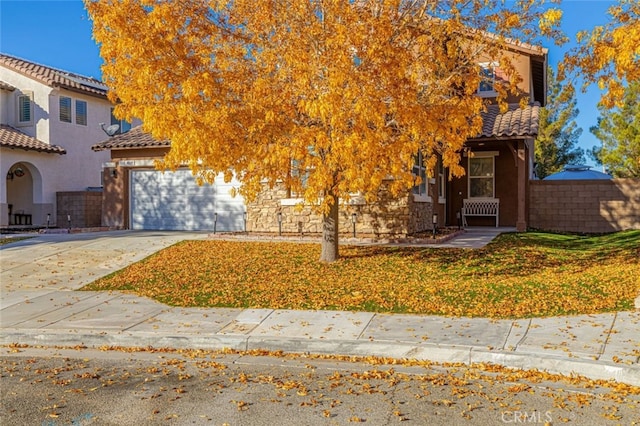 view of property hidden behind natural elements with a garage