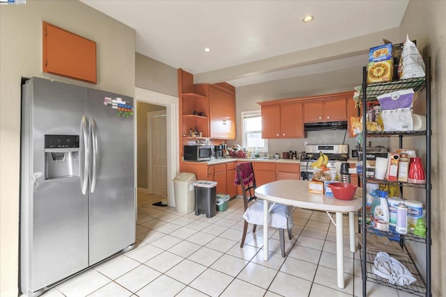 kitchen with light tile patterned floors and stainless steel appliances