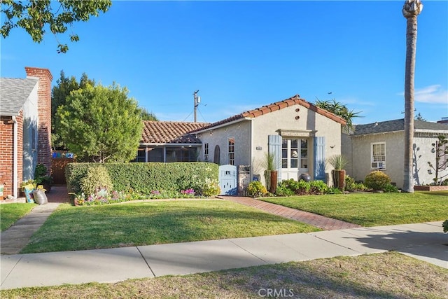 mediterranean / spanish-style home featuring a front lawn