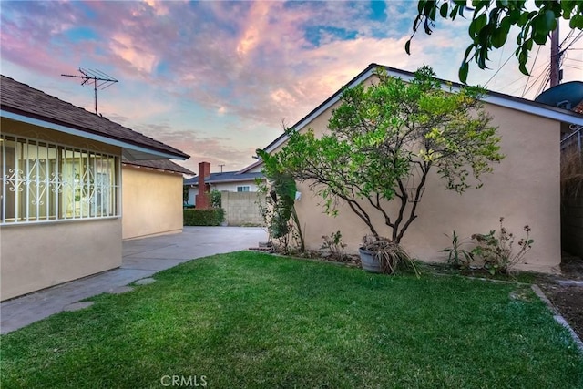 yard at dusk with a patio