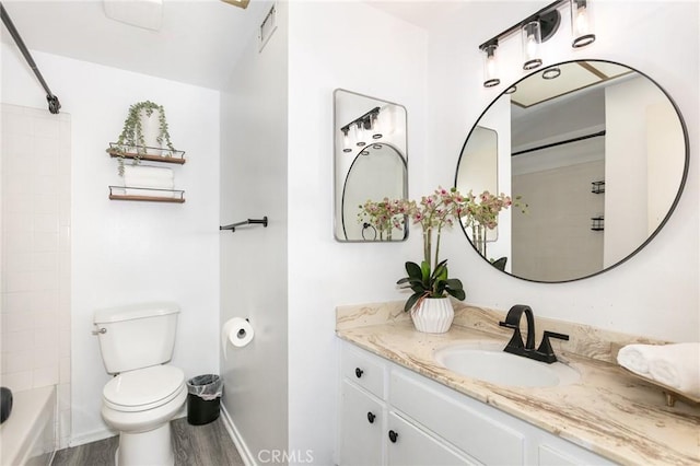 full bathroom featuring hardwood / wood-style flooring, vanity, toilet, and shower / bathing tub combination