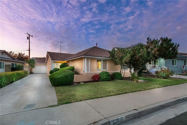 view of front of home featuring a lawn and a garage