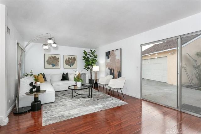 living room featuring a chandelier and wood-type flooring