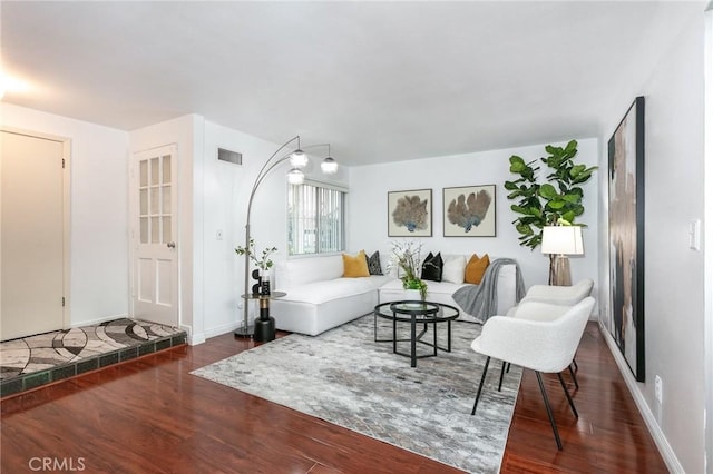 living room with dark hardwood / wood-style flooring