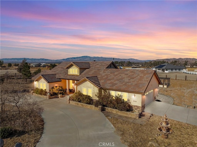 view of front of home featuring a mountain view and a garage