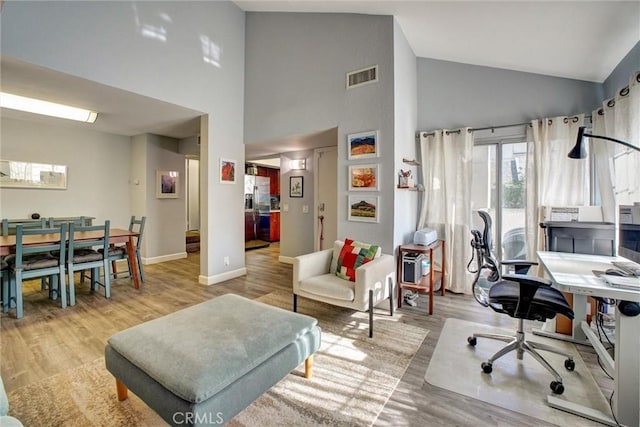 office area featuring light hardwood / wood-style flooring and high vaulted ceiling