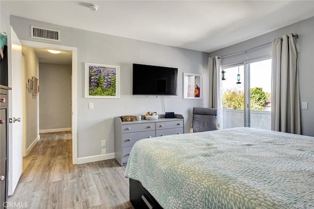 bedroom with light hardwood / wood-style floors and access to exterior