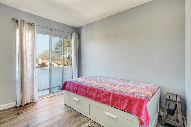 bedroom featuring access to outside and light hardwood / wood-style floors