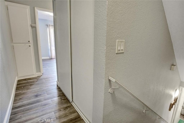 hallway with hardwood / wood-style flooring