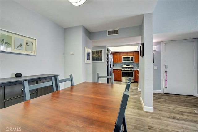 dining space with light wood-type flooring