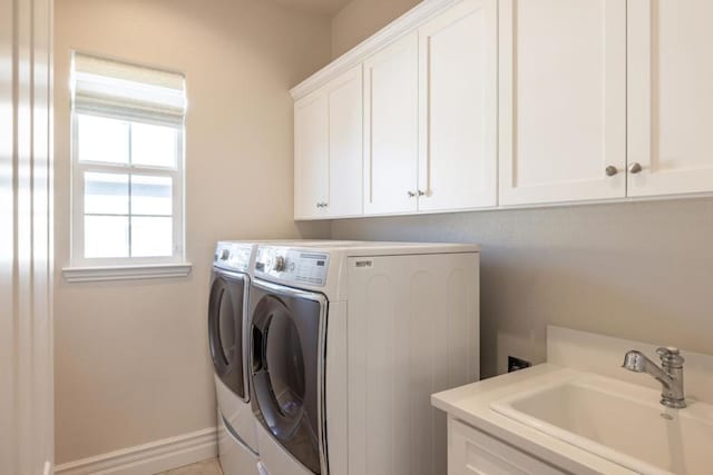 laundry area with sink, separate washer and dryer, and cabinets